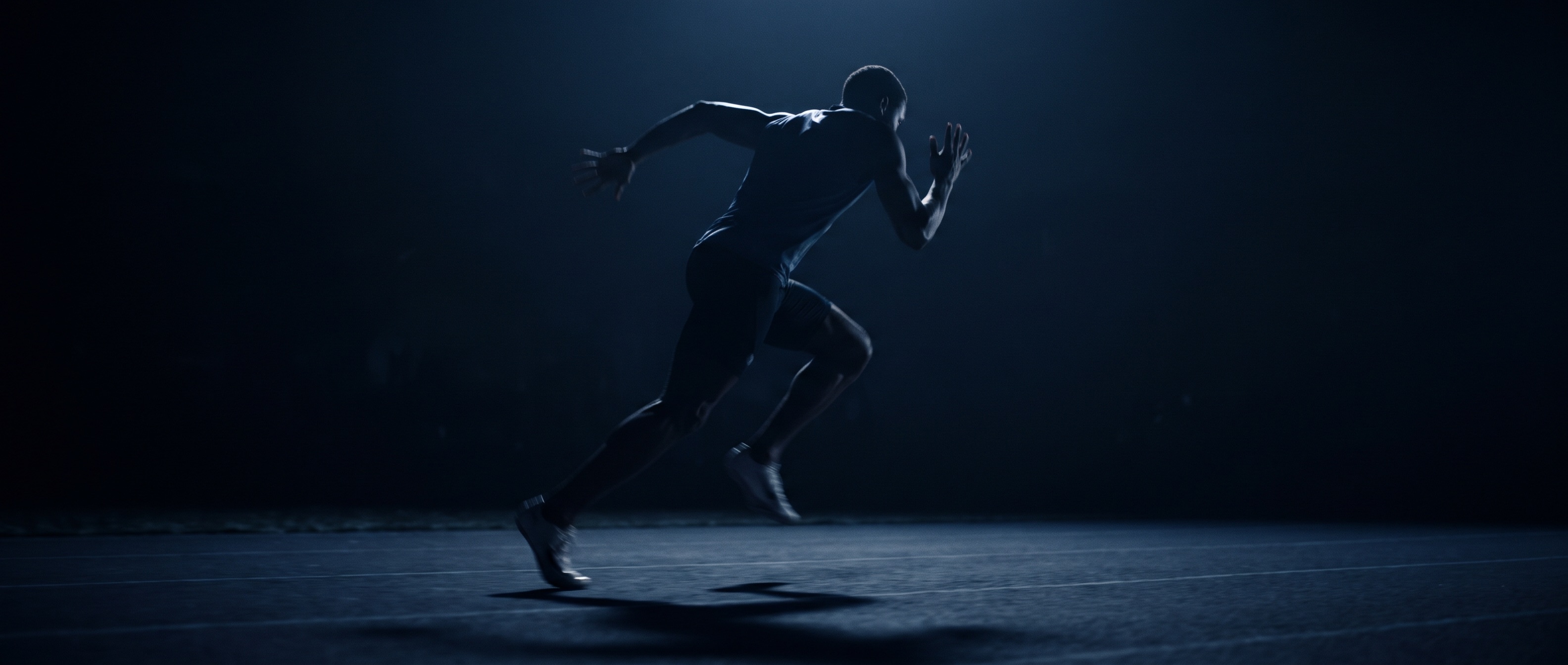 Sprinter driving out of the dark, lit by a single cold light